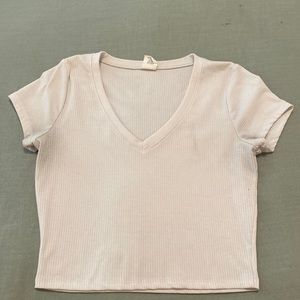 Cropped, tight, white shirt.